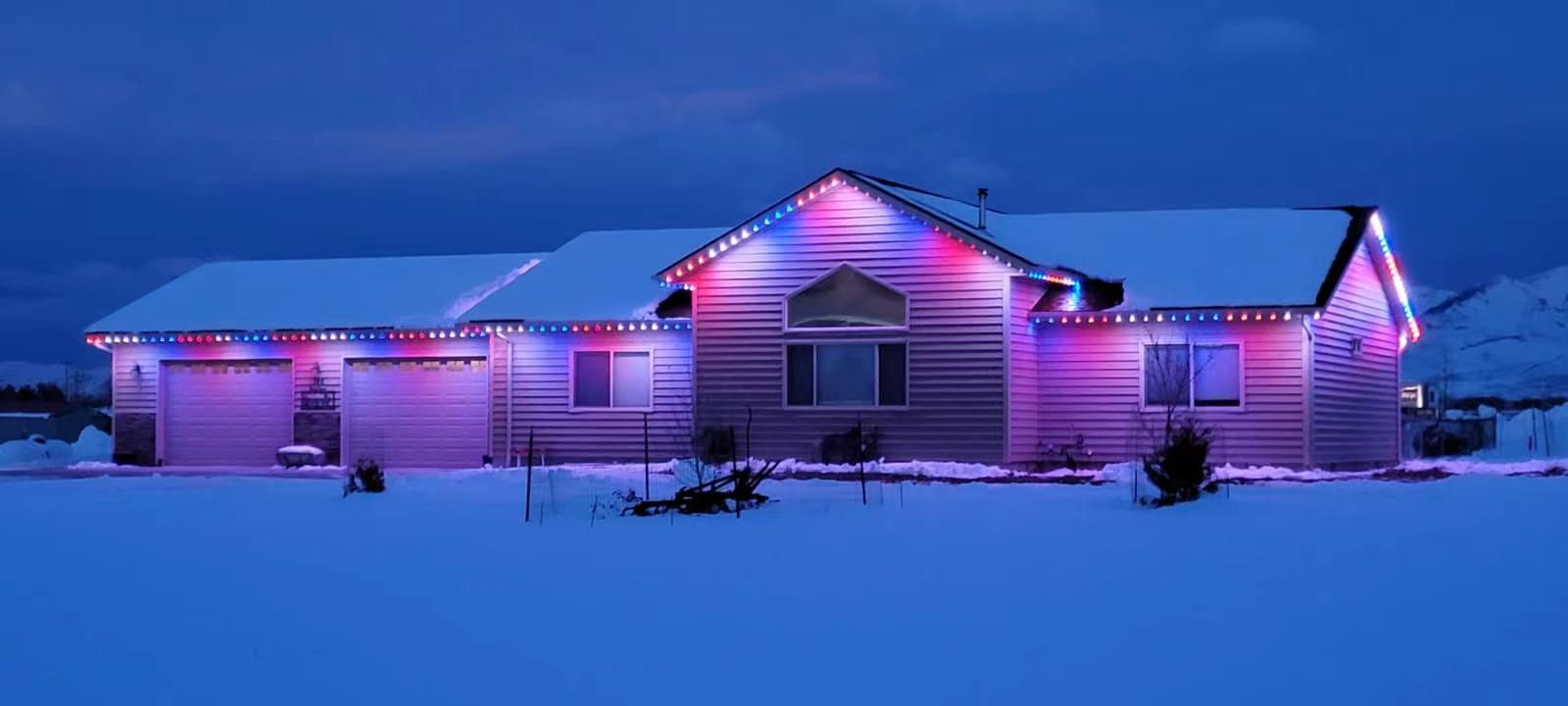 Permanent LED outdoor lighting installed on Edmonton home roofline with warm white glow